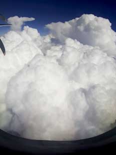 Clouds and sky seen from window of an aircraft