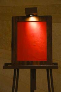 Surface light falling on red screen of standing board