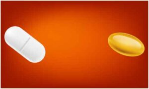 White tablet and yellow capsule display on red and orange background