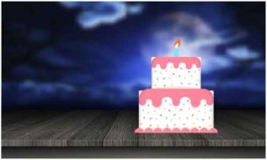 Birthday cake double storey with burning candle display on table